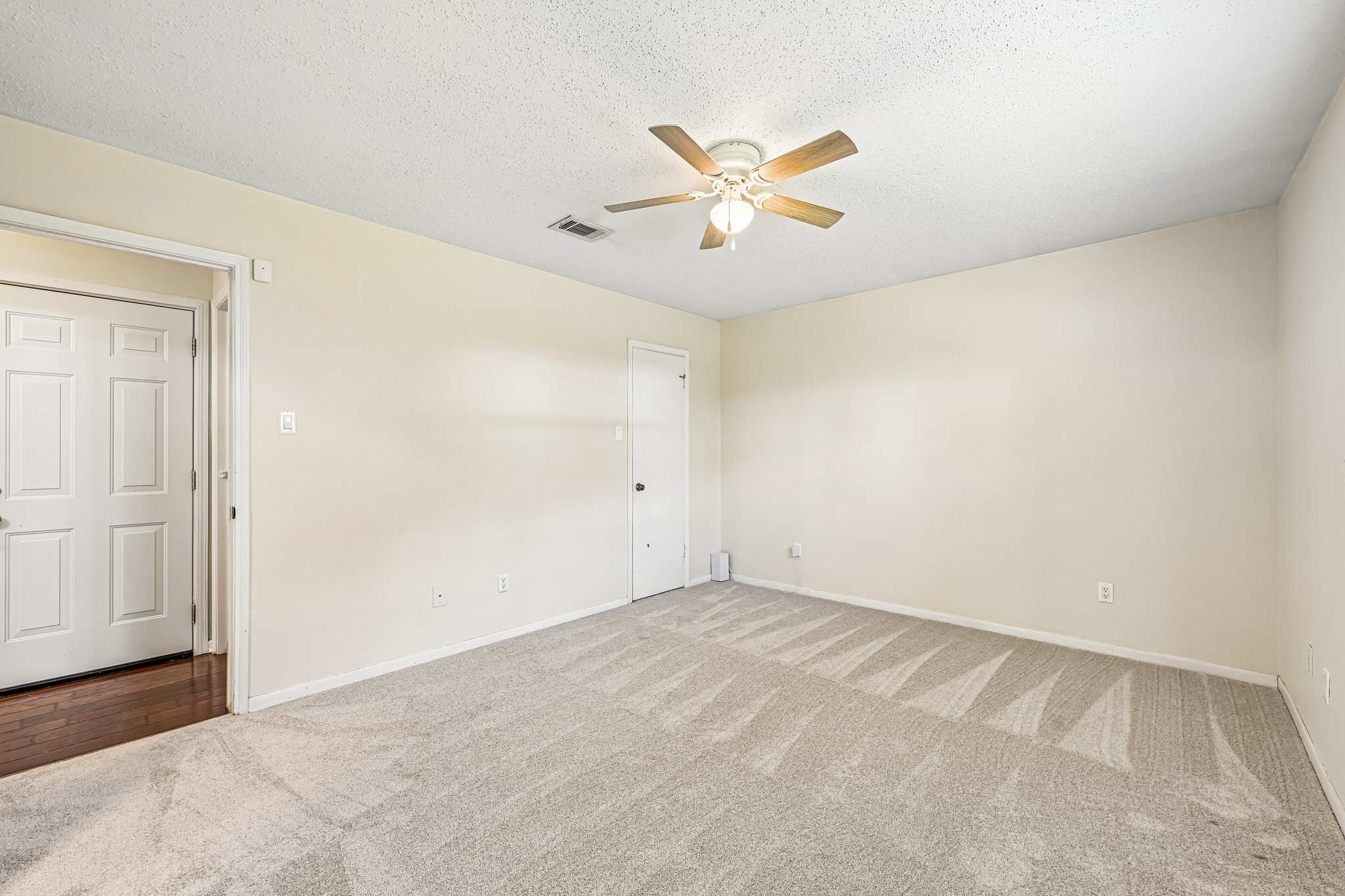 8 Arlington Street Conroe, TX 77301 - Photo 24 of 37 Primary Bedroom (off of downstairs hallway) showing door leading to walk-in closet.