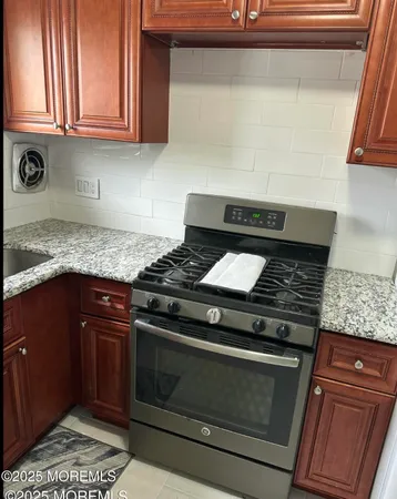 a stove top oven sitting inside of a kitchen