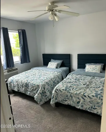a bedroom with two beds and a chandelier