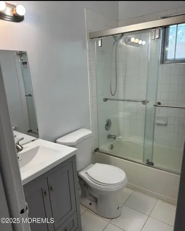 a bathroom with a toilet a sink and shower