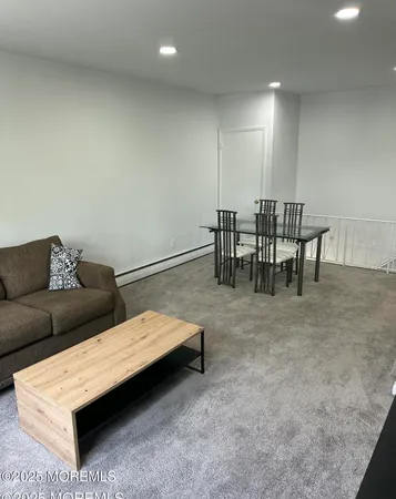 a living room with furniture and a dining table