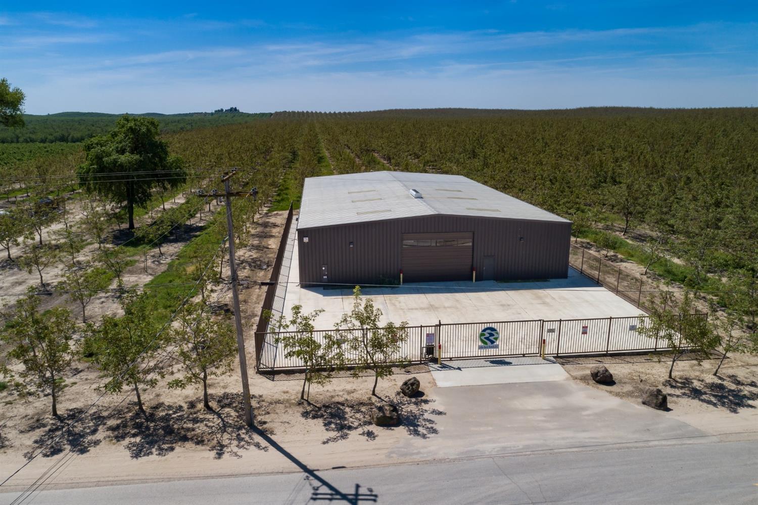 14954 Tim Bell Road Waterford, CA 95386 - Photo 9 of 28 a picture of a lake with a building in the background