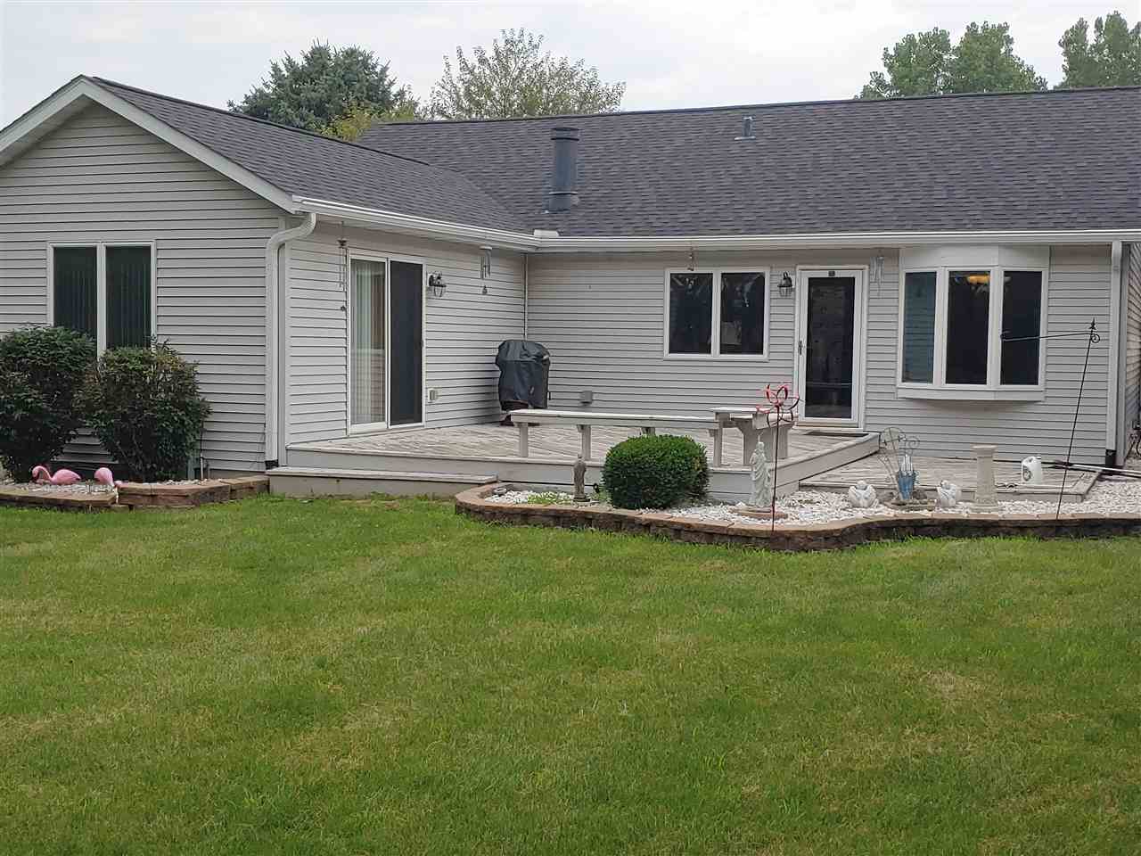 211 Rochester Road Northeast Poplar Grove, IL 61065 - Photo 12 of 17 a front view of house with yard and outdoor seating