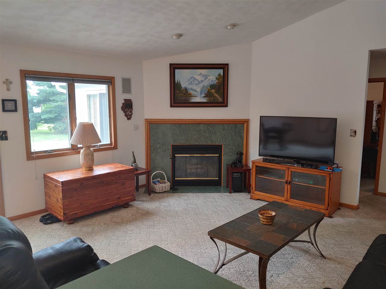 211 Rochester Road Northeast Poplar Grove, IL 61065 - Photo 3 of 17 a living room with furniture a flat screen tv and a fireplace
