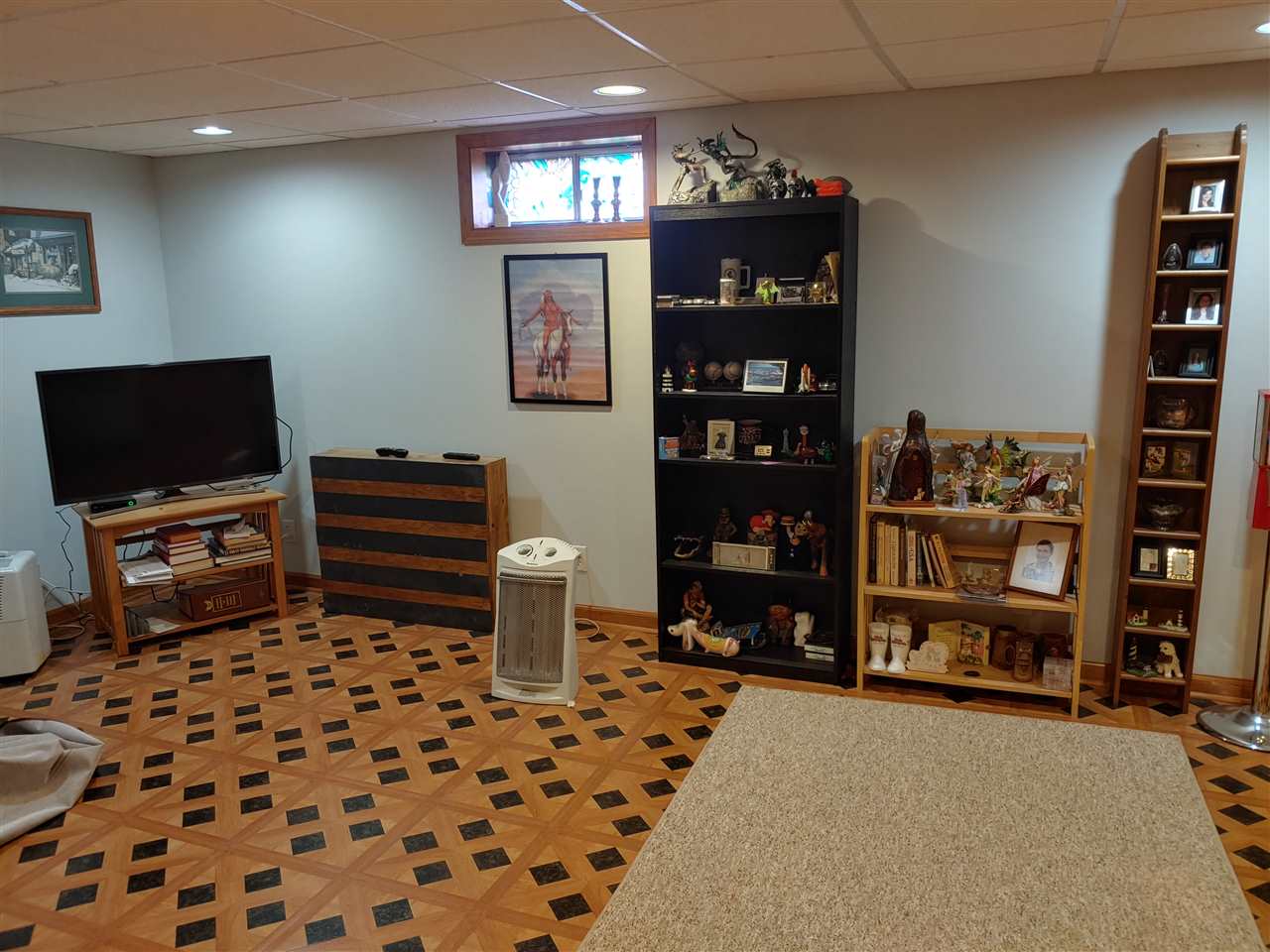 211 Rochester Road Northeast Poplar Grove, IL 61065 - Photo 8 of 17 a room with furniture a flat screen tv and a bookshelf