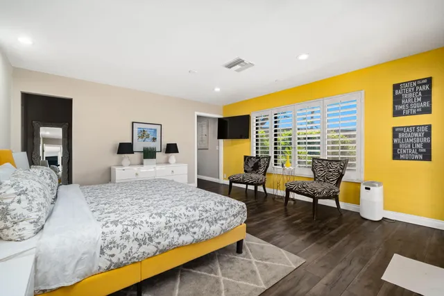 a view of a livingroom with workspace and a window