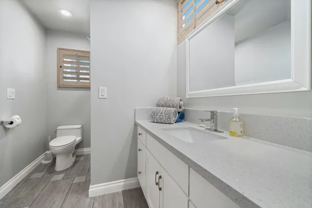 a bathroom with a toilet sink and mirror