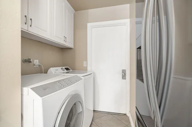 a view of a patio with a table and chairs under an umbrella