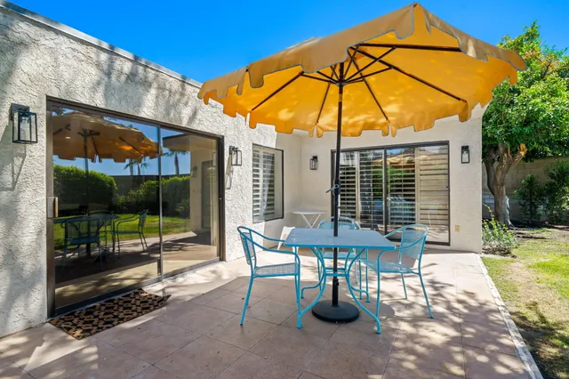 a view of a house with backyard porch and sitting area