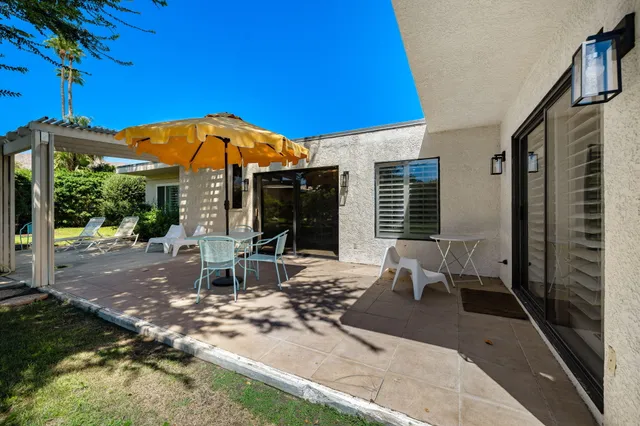 a view of a house with backyard sitting area and garden