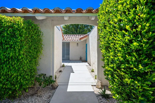 a pathway of a house with a yard