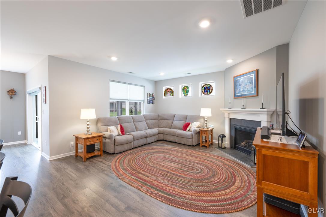 8078 Schaefer Crest Breinigsville, PA 18031 - Photo 16 of 35 a living room with furniture a fireplace and a flat screen tv