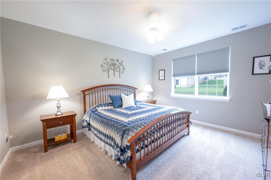 8078 Schaefer Crest Breinigsville, PA 18031 - Photo 19 of 35 a bedroom with a bed lamp and a window