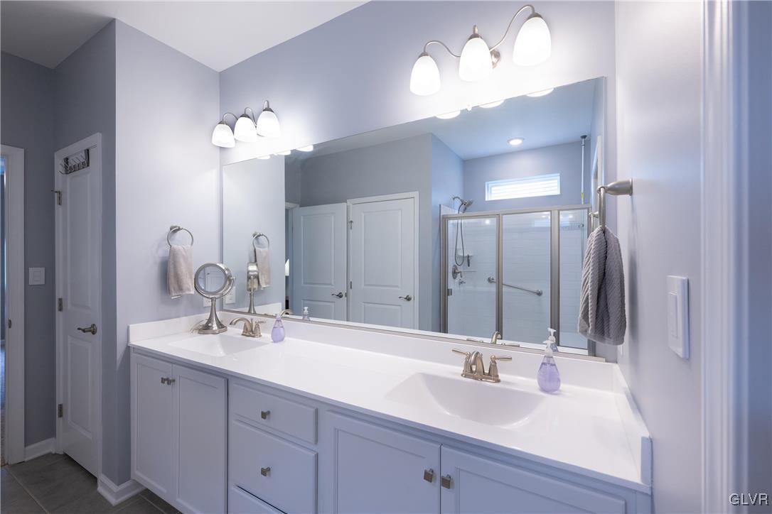 8078 Schaefer Crest Breinigsville, PA 18031 - Photo 21 of 35 a bathroom with a double vanity sink and a mirror