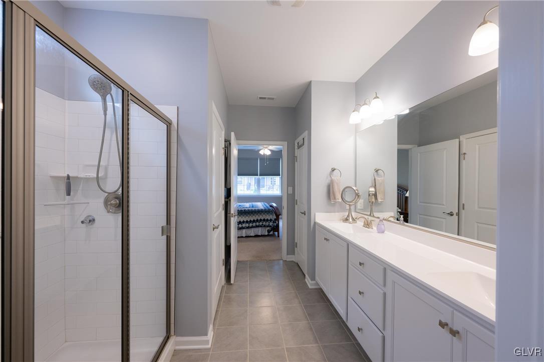 8078 Schaefer Crest Breinigsville, PA 18031 - Photo 22 of 35 a large bathroom with a double vanity sink and a mirror