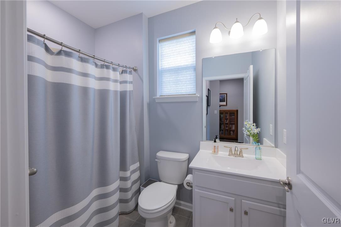 8078 Schaefer Crest Breinigsville, PA 18031 - Photo 23 of 35 a bathroom with a toilet a sink and a mirror