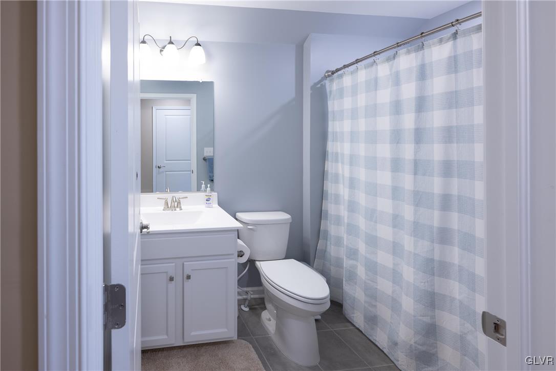 8078 Schaefer Crest Breinigsville, PA 18031 - Photo 30 of 35 a bathroom with a sink a toilet and shower curtain