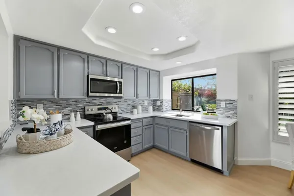 a kitchen with a sink stove and microwave