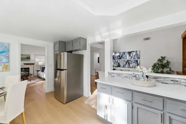 a kitchen with refrigerator and cabinets