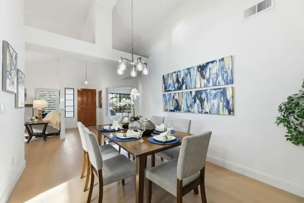 a view of a dining room with furniture and chandelier