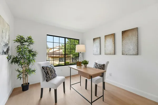 a dining room with furniture and window
