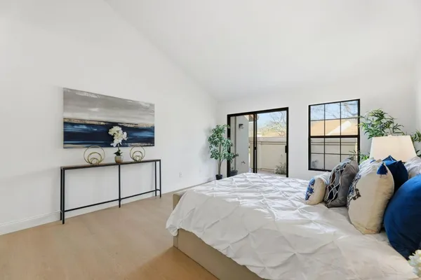 a bedroom with a bed and large window