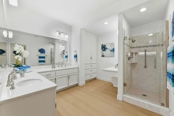 a bathroom with a granite countertop sink mirror and shower