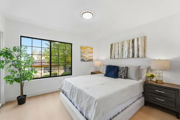 a bedroom with furniture and a potted plant
