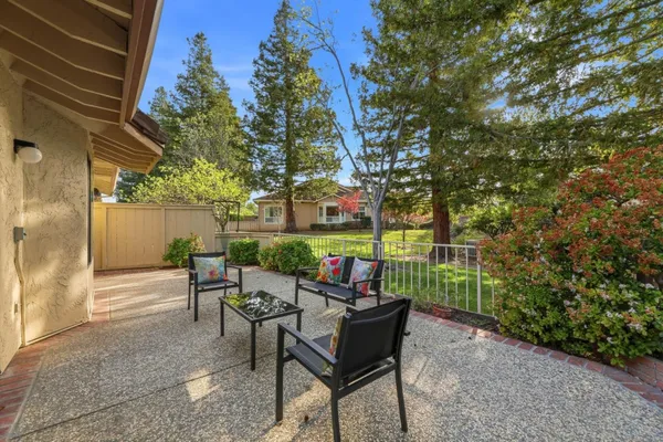 a view of a house with backyard sitting area and sitting area