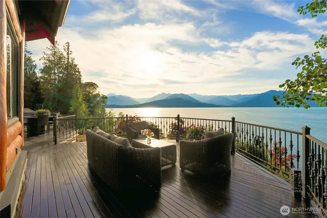 a view of a balcony with mountain view and wooden floor