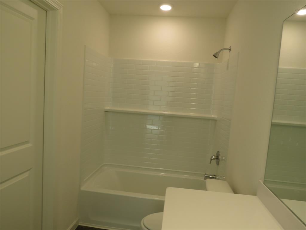 1906 Chapel Hill Road Princeton, TX 75407 - Photo 25 of 36 a bathroom with a toilet and shower