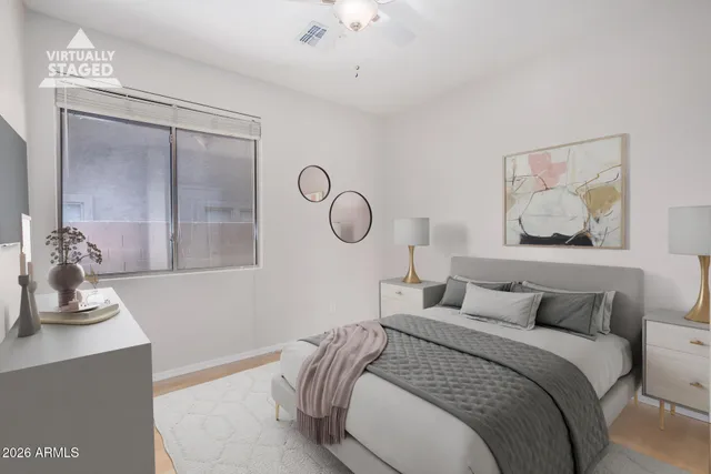 a bedroom with bed and a chandelier