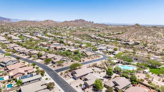 an aerial view of residential houses with outdoor space and trees