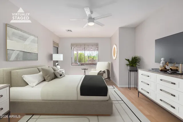 a bedroom with a large bed and a dresser