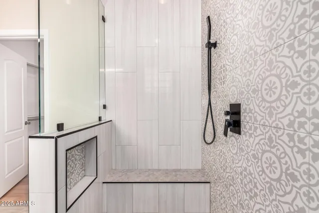 a bathroom with a shower and a mirror