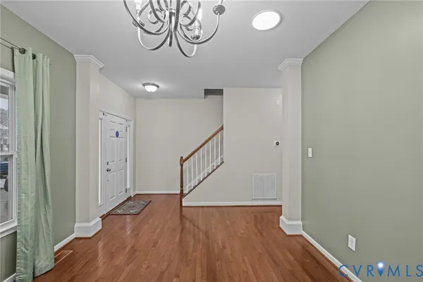 a kitchen with stainless steel appliances granite countertop a stove top oven a sink dishwasher a refrigerator and cabinets with wooden floor