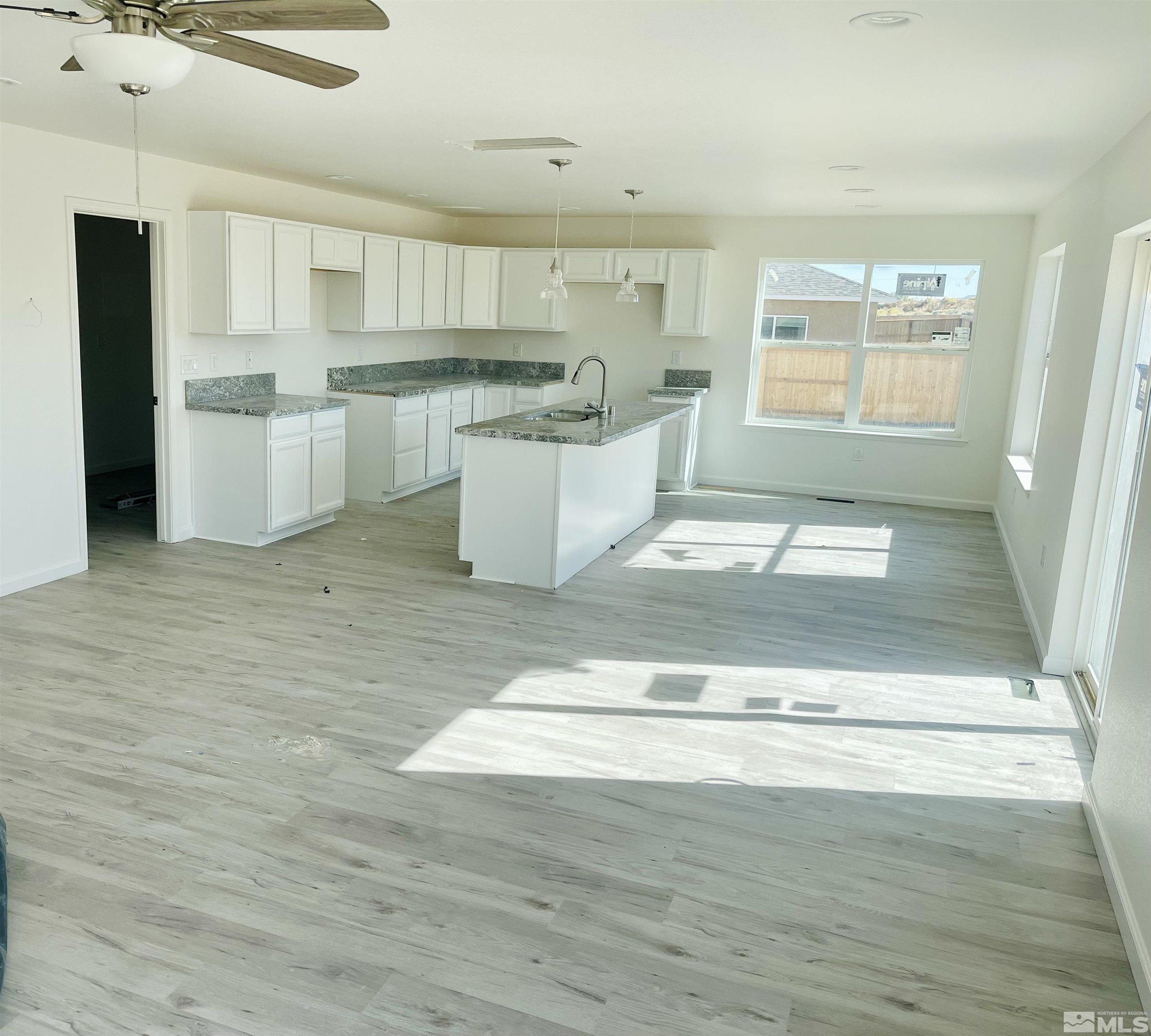 1318 Serenity Circle Fernley, NV 89408 - Photo 3 of 13 a open kitchen with kitchen island a sink stainless steel appliances and cabinets