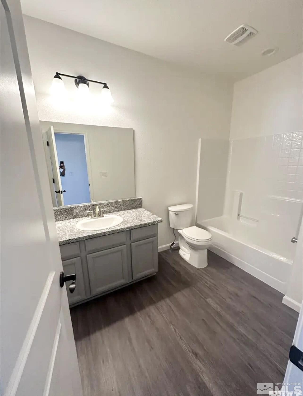 1318 Serenity Circle Fernley, NV 89408 - Photo 6 of 13 a bathroom with a double vanity sink mirror and toilet