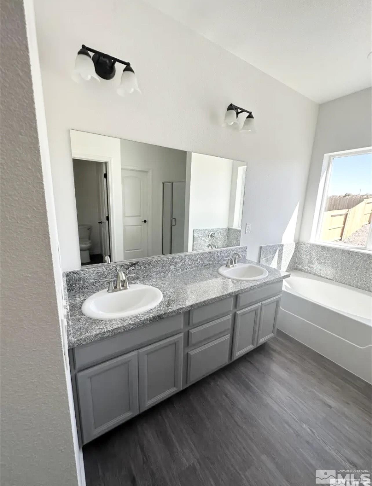1318 Serenity Circle Fernley, NV 89408 - Photo 7 of 13 a bathroom with a granite countertop sink and a mirror