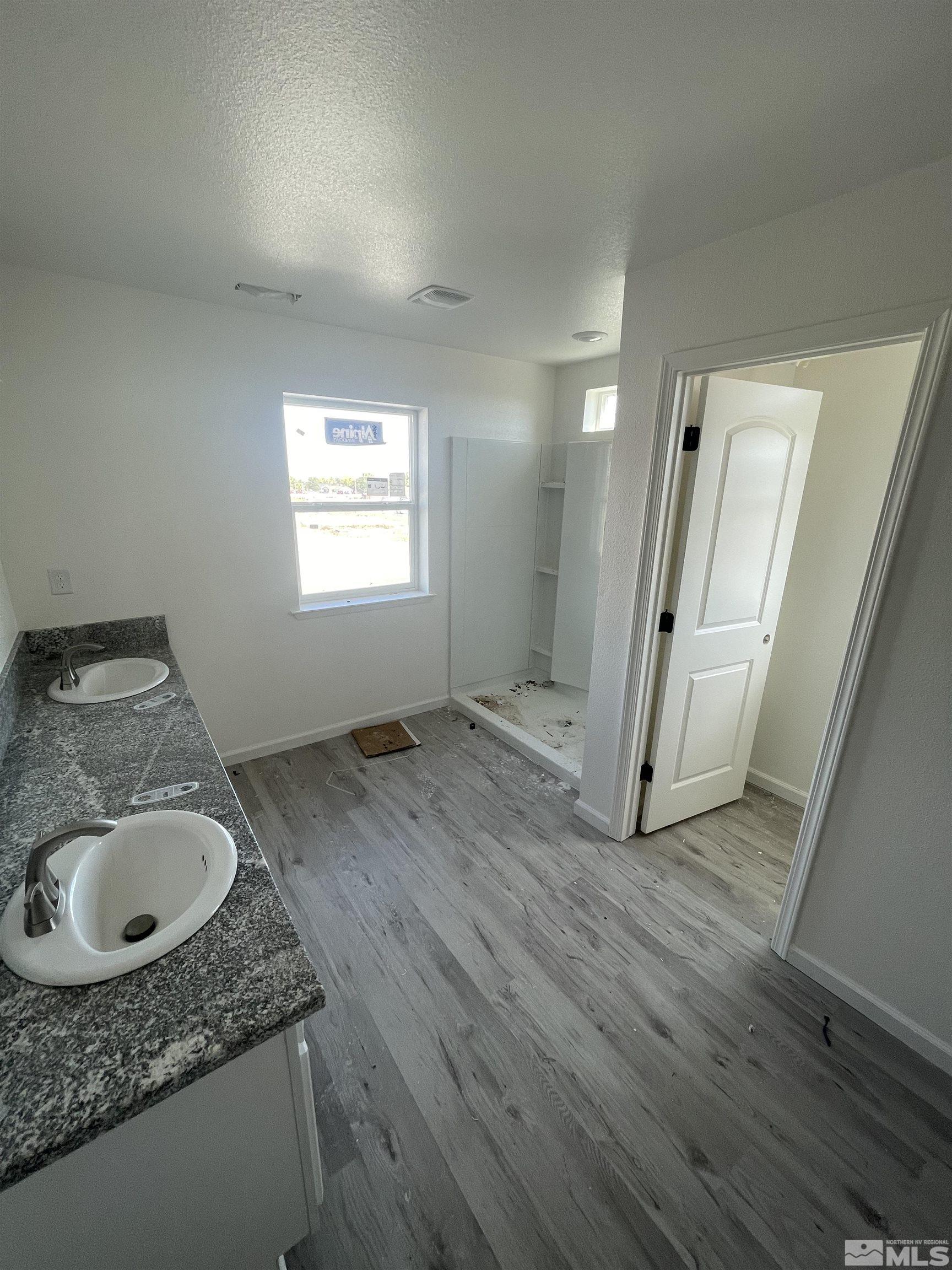 1318 Serenity Circle Fernley, NV 89408 - Photo 9 of 13 a bathroom with a granite countertop sink and a mirror