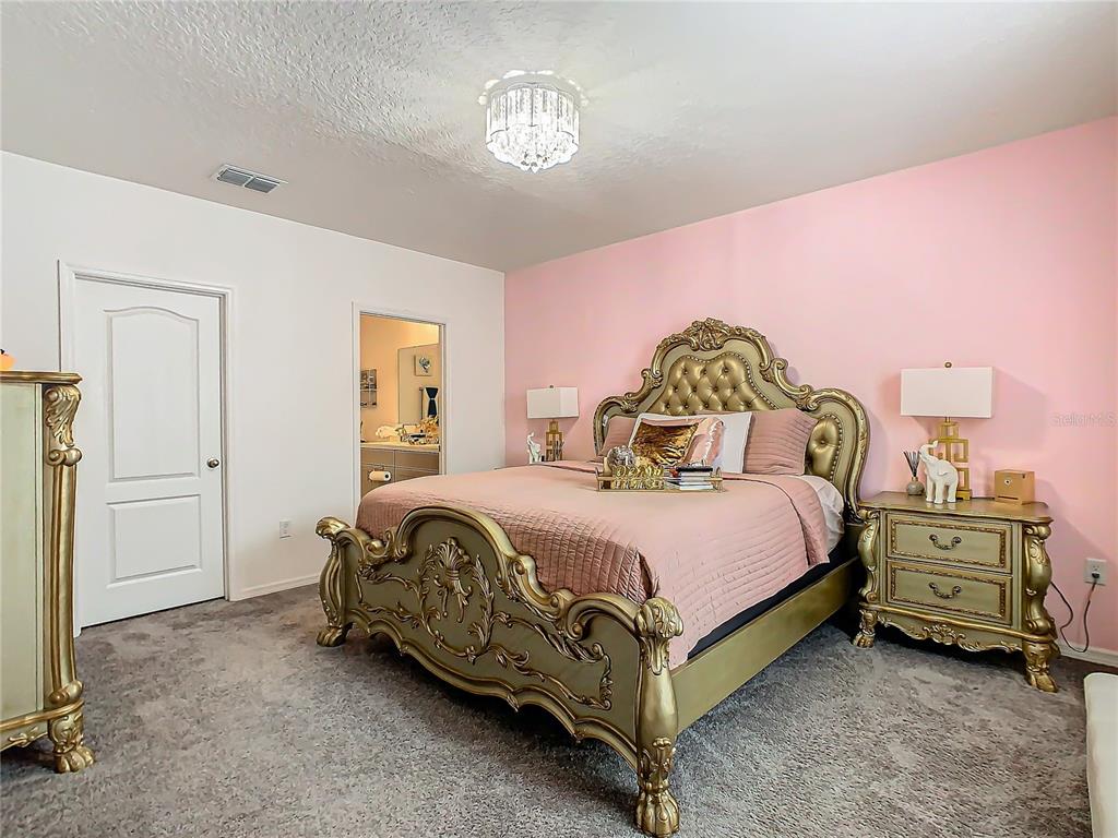 208 Goldenrod Lane Kissimmee, FL 34759 - Photo 19 of 40 a bedroom with a bed and window