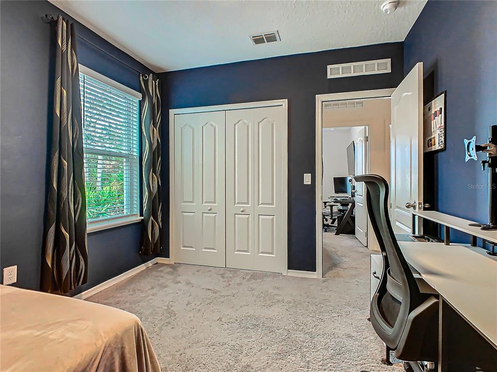 208 Goldenrod Lane Kissimmee, FL 34759 - Photo 22 of 40 a bedroom with a bed next to a window