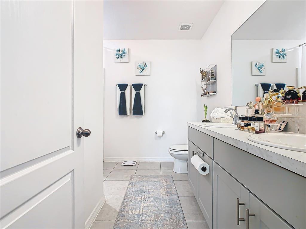 208 Goldenrod Lane Kissimmee, FL 34759 - Photo 25 of 40 a room with a sink and a mirror