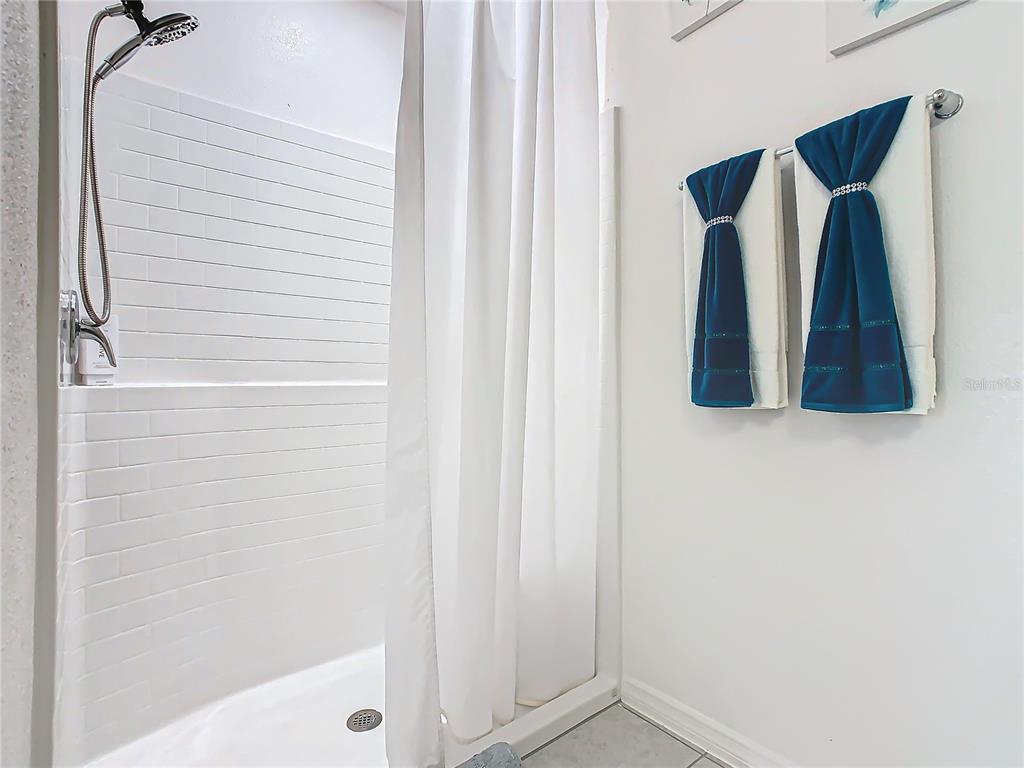 208 Goldenrod Lane Kissimmee, FL 34759 - Photo 27 of 40 a bathroom with a shower and a tub