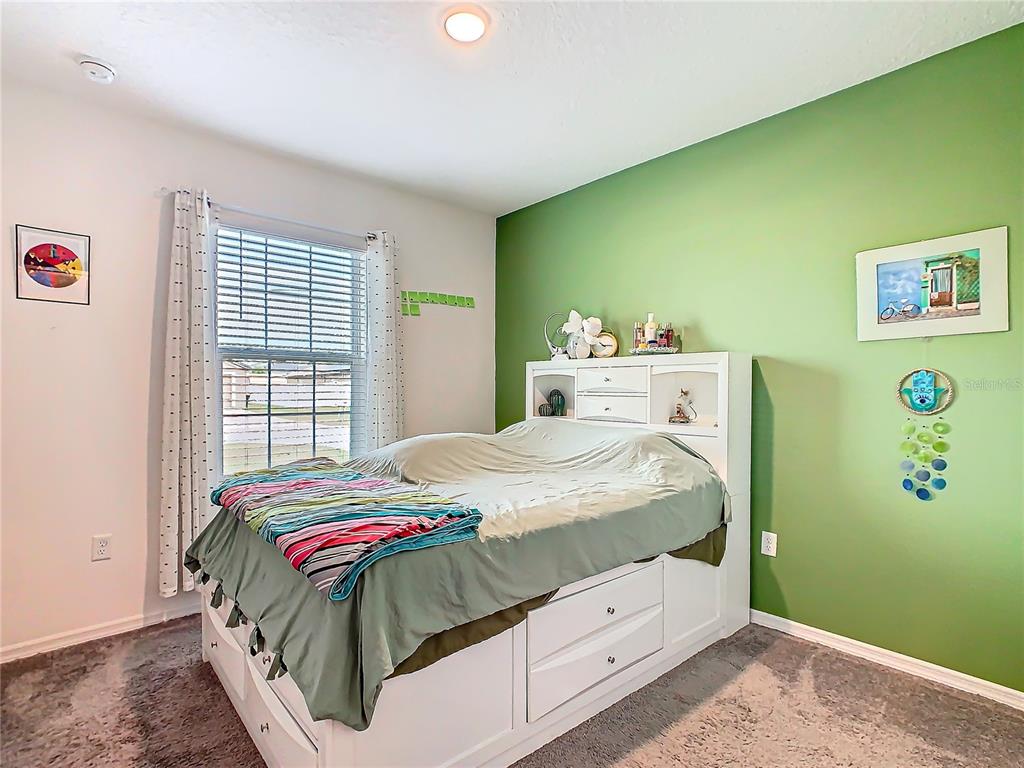 208 Goldenrod Lane Kissimmee, FL 34759 - Photo 32 of 40 a bedroom with a bed and a window