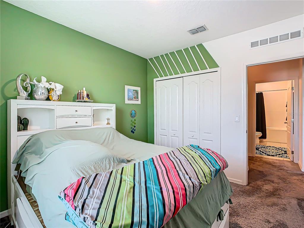 208 Goldenrod Lane Kissimmee, FL 34759 - Photo 33 of 40 a bedroom with a bed and a walk in closet