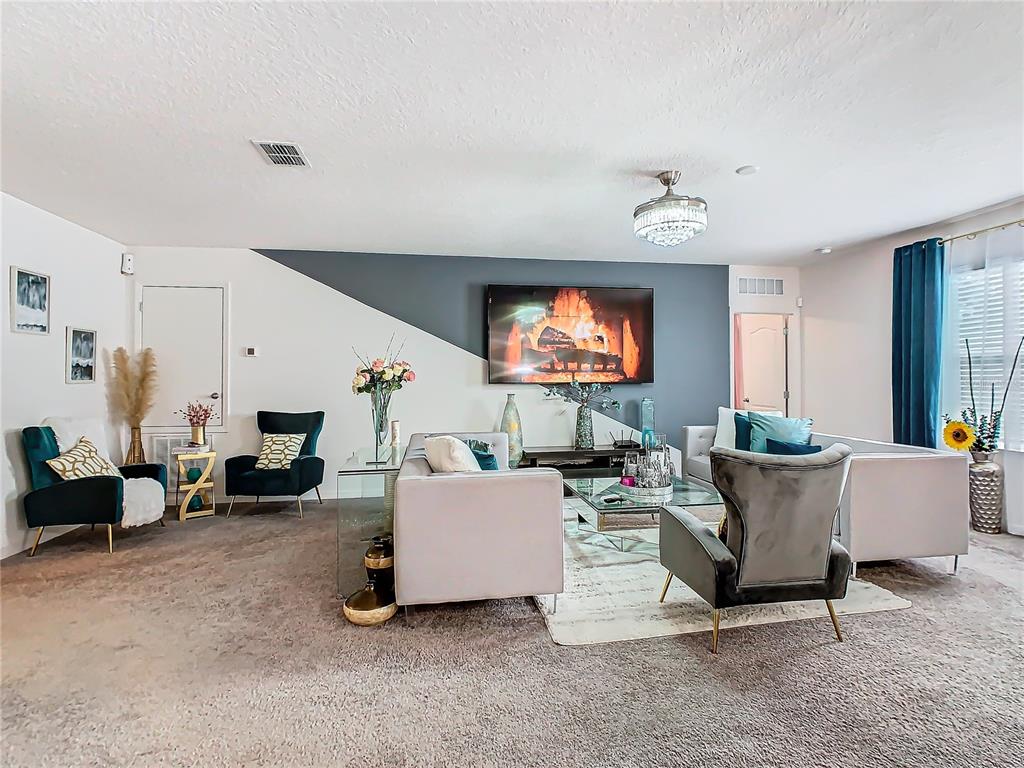208 Goldenrod Lane Kissimmee, FL 34759 - Photo 5 of 40 a living room with furniture and a flat screen tv