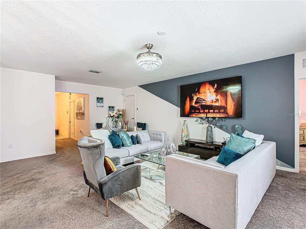 208 Goldenrod Lane Kissimmee, FL 34759 - Photo 6 of 40 a living room with furniture and a flat screen tv