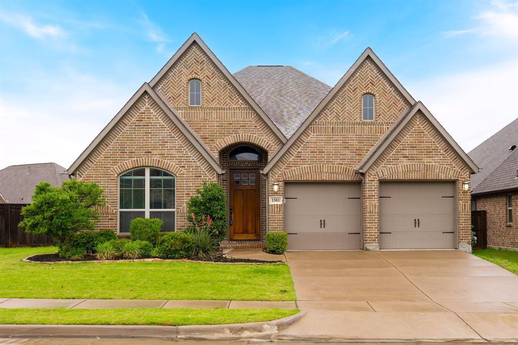 1501 Calcot Lane Forney, TX 75126 - Photo 1 of 34 Brick exterior featuring gabled rooflines and arched window details