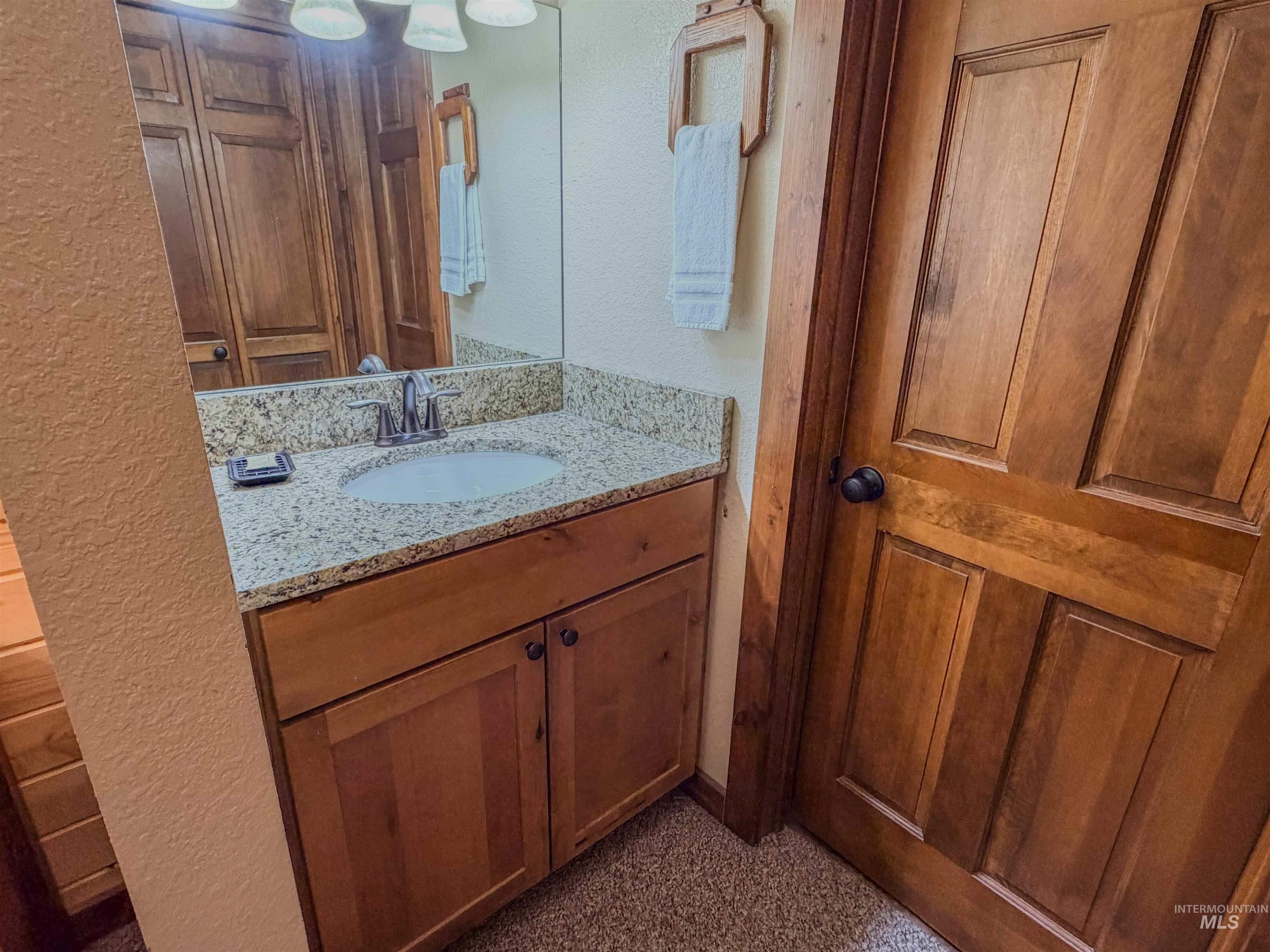 1607 Davis Avenue, Unit C6 McCall, ID 83638 - Photo 15 of 30 Half bath featuring a textured wall and vanity
